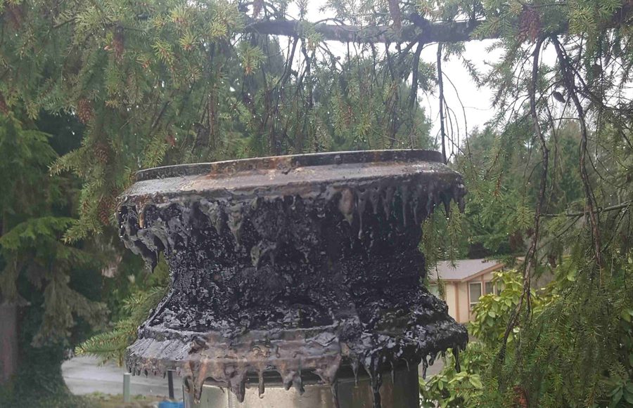 Heavy creosote buildup dripping from a chimney cap